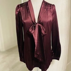 New authentic Burberry silk stretchy blouse in burgundy  with a bow on a front.